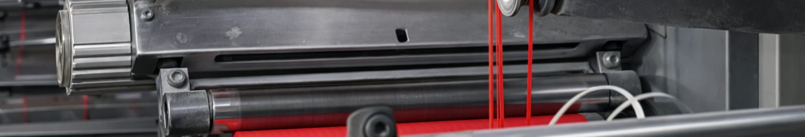 Film rollers loaded with red polymer web